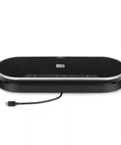 Black rectangular wireless speaker with silver edges and a USB cable on a tabletop.
