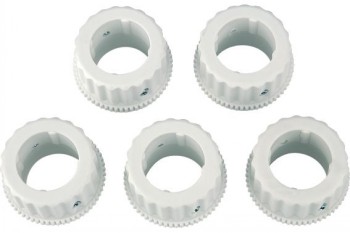 Five white round plastic valve adapters with grooved edges.