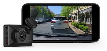Garmin Dash Cam Mini X210 compact dash camera with video presentation. Garmin Dash Cam Mini X210 dash camera in black, adjacent smartphone displays recorded video of a car and the street.