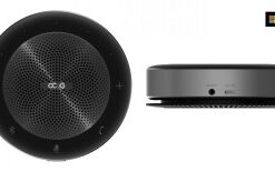Round, black speaker with buttons on the edge. Side profile and top view.