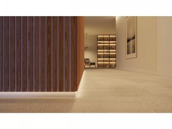 PHILIPS HUE Solo Lightstrip accent lighting in a modern interior A light modern interior, PHILIPS HUE Solo Lightstrip illuminates the baseboard with a warm tone, wooden panelling in the background.