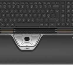 A black-and-white wireless keyboard and ergonomic roller mouse with a cushioned wrist rest, viewed from above.