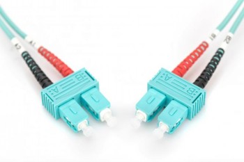 Digitus FO Patch Cord SC-SC, turquoise duplex cable, 1 m Light blue SC connectors connected to a turquoise duplex FO patch cable, red and black protective caps visible...