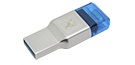 A silver USB-C and USB-A memory card reader with a blue protective cap, on a tabletop.
