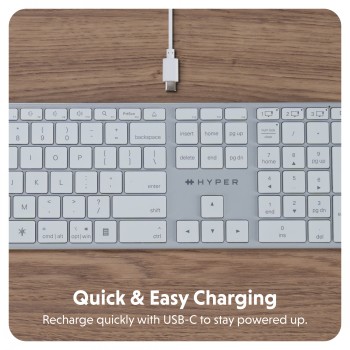 Targus Hyper Hyperspace Bluetooth keyboard and charging cable Silver-colored Targus Hyper Hyperspace Bluetooth keyboard on a wooden desk, includes a USB-C charging cable.