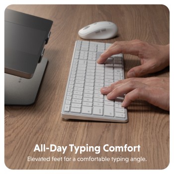 Targus Hyper Hyperspace Bluetooth keyboard with ergonomic design. A person typing on a white wireless Bluetooth keyboard on a wooden table, with a white mouse next to it.