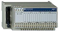 Gray-cased Schneider Electric Modicon Telefast module, 16 labeled outputs on the front panel.